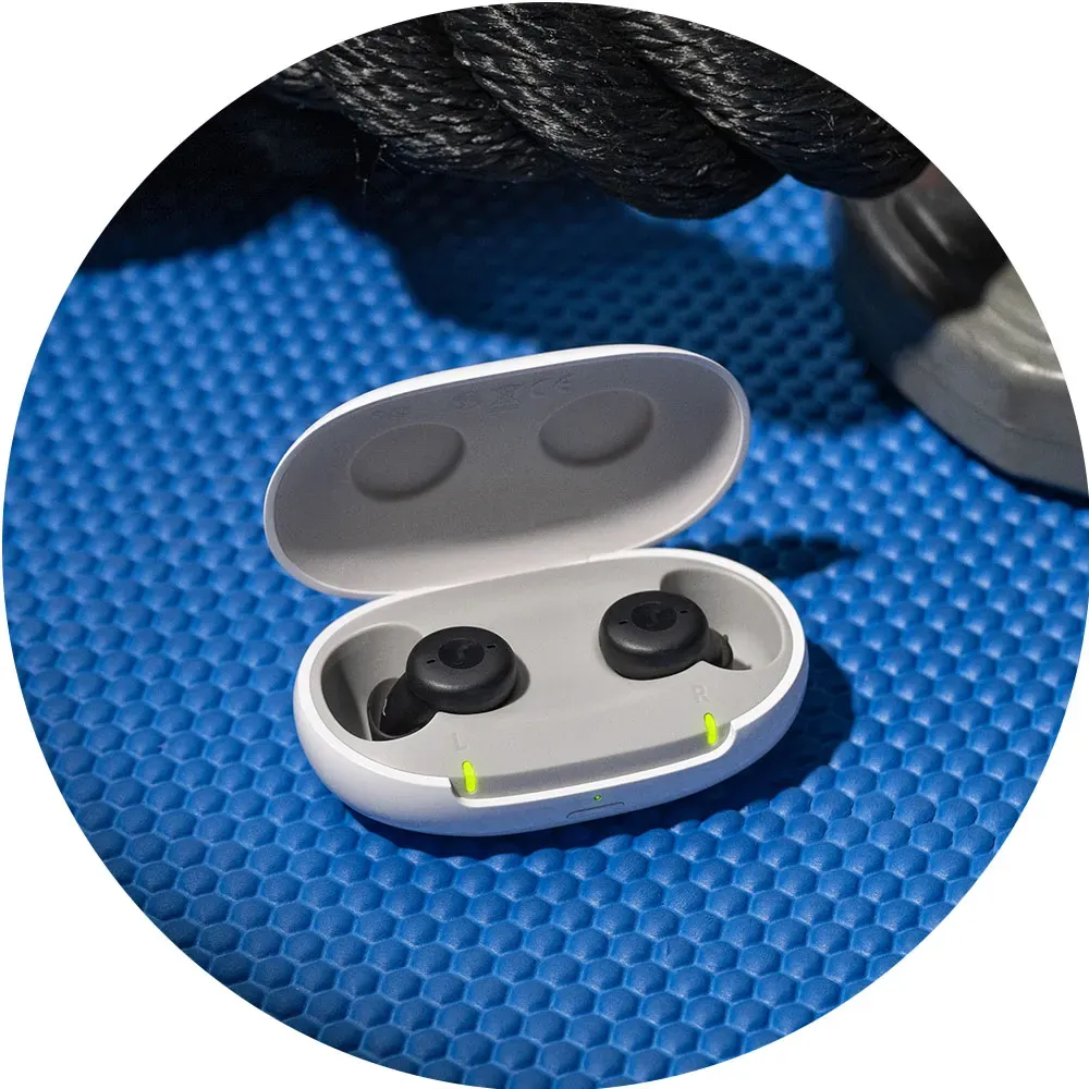 Rechargeable Hearing Aids shown with their charger. Inside the canal model