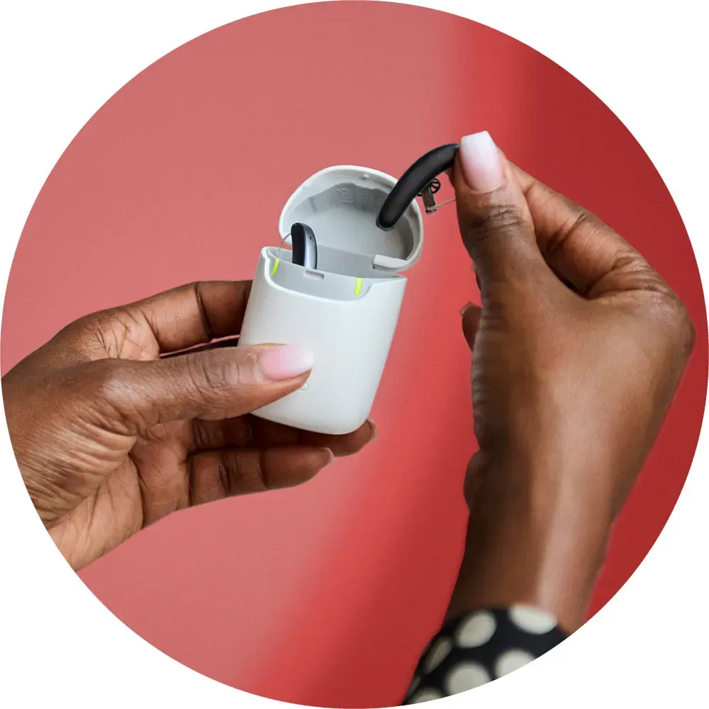 Rechargeable Hearing Aids shown with their charger